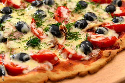 homemade pizza, vegetarian food, baked vegetables and cheese, tomatoes and olives, delicious food on a wooden background