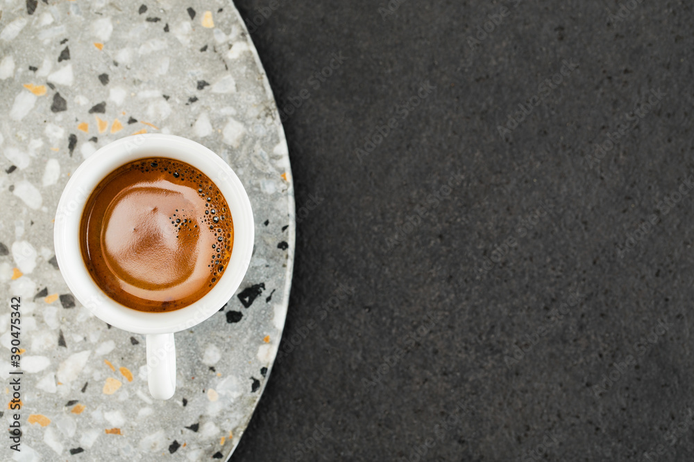 Cup of espresso on terrazzo coffee table
