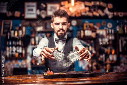 Bartender mixes a cocktail in the pothouse photo