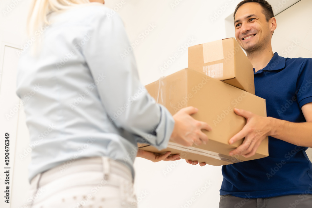 Delivery man holding cardboard boxes. Fast and free Delivery transport . Online shopping and Express delivery . Quarantine Delivery man holding cardboard boxes. Fast and free Delivery transport . Online shopping and Express delivery . Quarantine