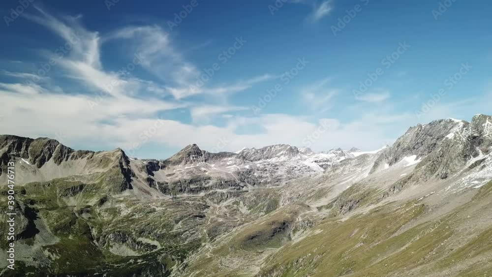 A panoramic drone shot of slopes in the Hohe Tauern region in Austria. The slopes are partially covered with snow. Upper parts steep and sharp. There is an Alpine lake at the bottom. Serenity
A panoramic drone shot of slopes in the Hohe Tauern region in Austria. The slopes are partially covered with snow. Upper parts steep and sharp. There is an Alpine lake at the bottom. Serenity