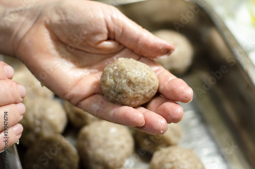 The chef makes meat patties. Cutlet in the hands of a woman cook