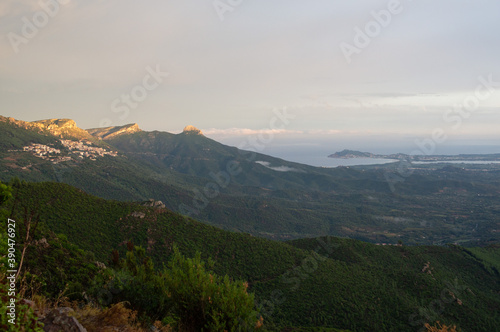 View of a typical Italian village at sunset, Baunei Sardinia, Italy. Sea in the background.