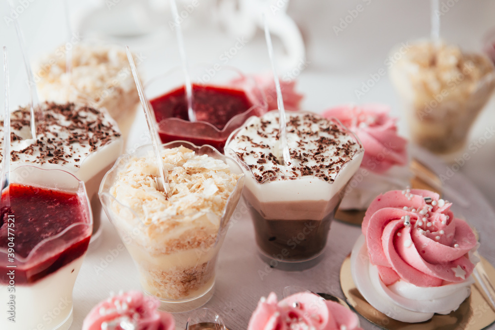 Banquet in the restaurant or cafe. Served table setting with fresh cupcakes sweets, candies with jelly and sugar. Gourmet tiramisu italian dessert birthday tasty chocolate. Banquet in the restaurant or cafe. Served table setting with fresh cupcakes sweets, candies with jelly and sugar. Gourmet tiramisu italian dessert birthday tasty chocolate.