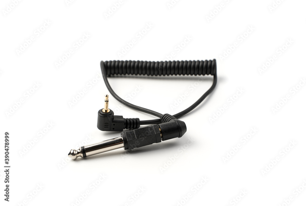 The sync cable with the connector and plug is isolated on a white background. Concept of accessories for equipment. The sync cable with the connector and plug is isolated on a white background. Concept of accessories for equipment.