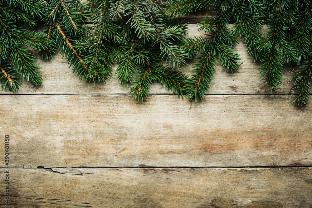 Wooden background with Christmas tree branches. Christmas banner Wooden background with Christmas tree branches. Christmas banner