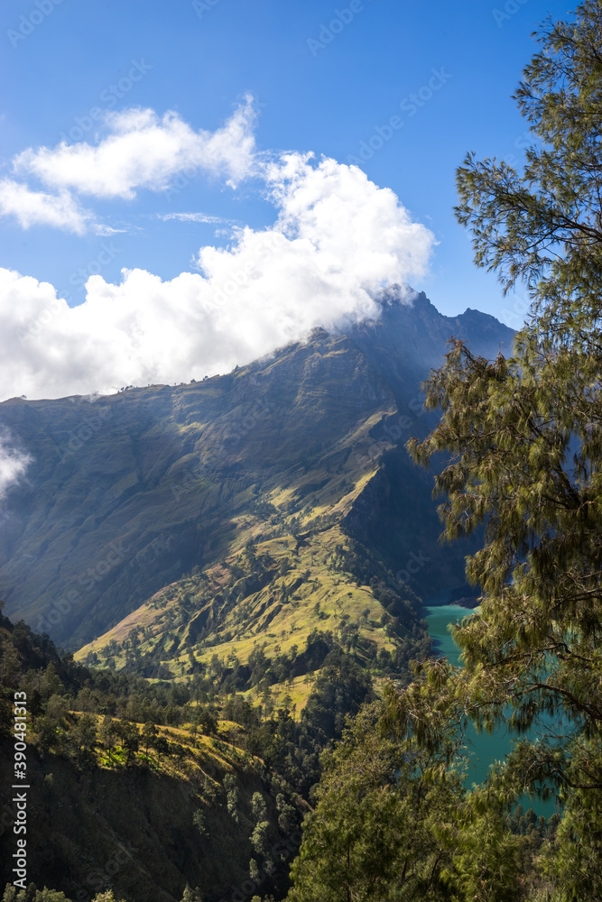 Mountains and green phosphor river, landscape with clouds in the morning, beautiful volcano Rinjani Gurung at Lombok Island, Indonesia. Small lake in the mountains