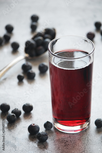 A glass full of blueberry juice 