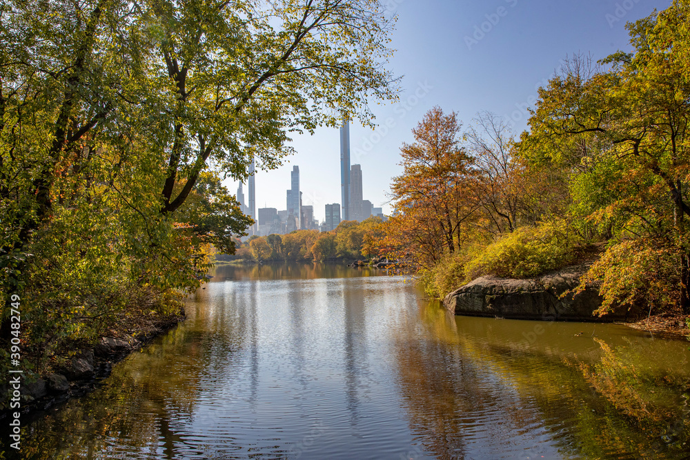 Trees and buildings reflect off the Lake from Bank Rock Bridge