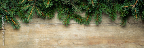 Wooden background with Christmas tree branches and snow. Christmas concept. Banner. Flat lay, top view