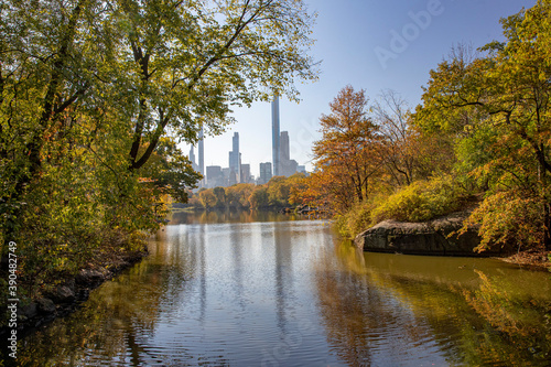 Trees and buildings reflect off the Lake from Bank Rock Bridge