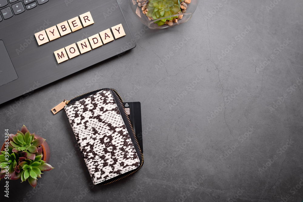 Obraz premium Cyber monday flat lay with wallet, credit card, laptop and succulent plant. Online shopping from home, safe shopping concept, top view, web banner