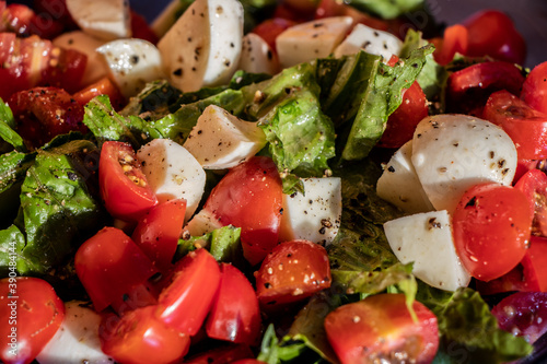 Caprese salad of cheese, lettuce and tomato close up photo