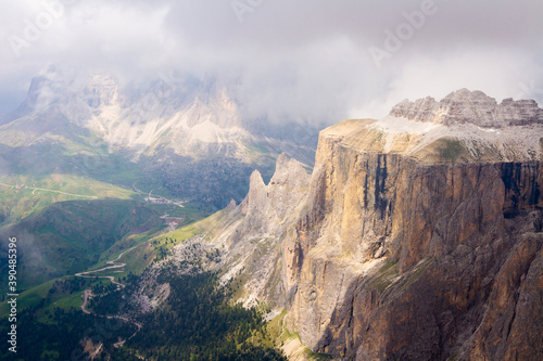 spectacular mountains in nice light coming over clouds, view to the valley from the top, italy, dolomites © Roman