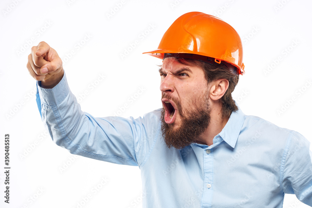 Angry man in orange hard hat industry work dissatisfaction cropped view Angry man in orange hard hat industry work dissatisfaction cropped view