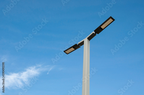 a metal design lamppost against a clear blue sky background