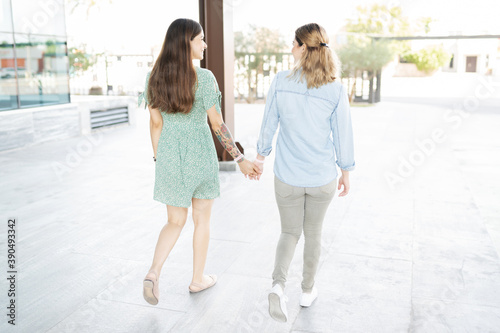 Two young lesbians walking from behind photo