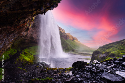 Fototapeta Naklejka Na Ścianę i Meble -  Sunrise on Seljalandfoss waterfall on Seljalandsa river, Iceland, Europe. Great purple sky glowing on background. Landscape photography