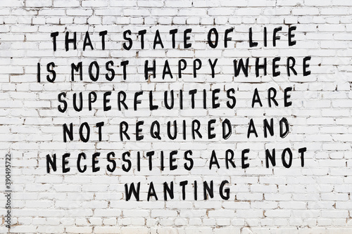 White brick wall with painted black inscription of wise quote photo