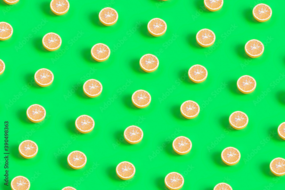 Fresh oranges halves pattern on a green background Fresh oranges halves pattern on a green background