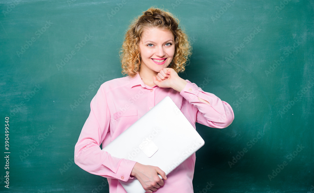 Software for teachers. School lecturer with notebook. Woman cheerful teacher hold laptop stand near chalkboard. School education concept. Modern education. Teaching informatics. Back to school Software for teachers. School lecturer with notebook. Woman cheerful teacher hold laptop stand near chalkboard. School education concept. Modern education. Teaching informatics. Back to school