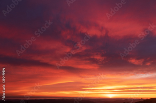 Fiery orange sunset sky. Dramatic sky with red glowing clouds. Natural background for your landscape project © Ivan Kmit