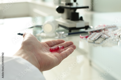 Doctor s hand points to the table with medicines