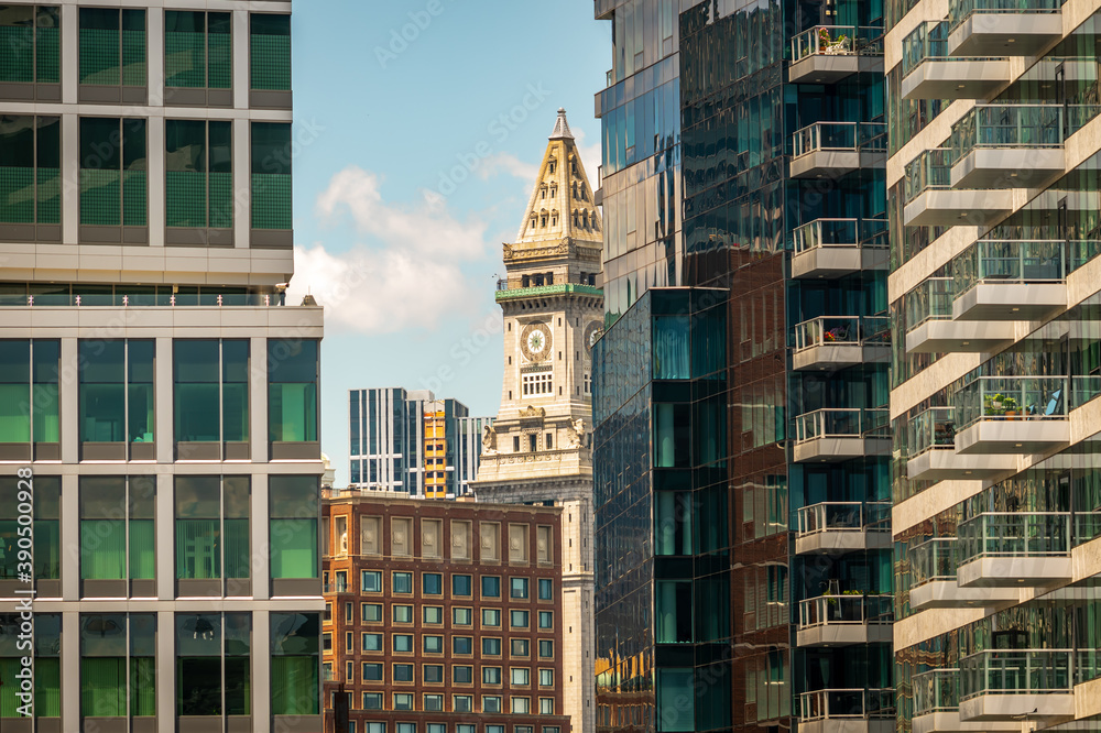 Fototapeta premium An historic Boston skyscraper, through the new glass buildings of the Seaport