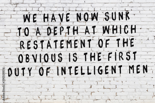 Painted black mindful inscription on white brick wall background photo