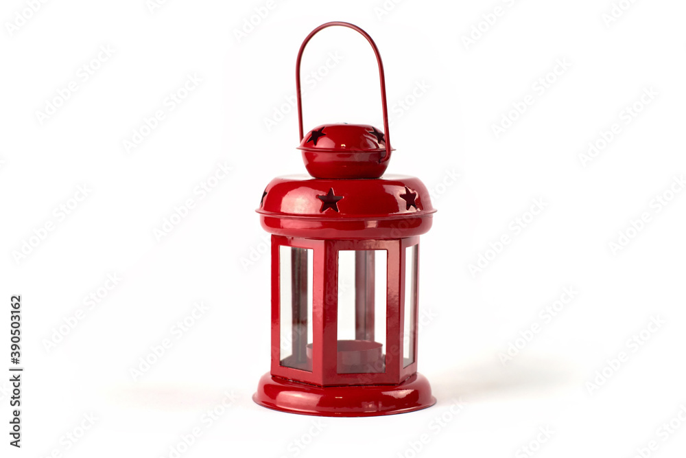 Obraz premium Red metal lantern-candlestick. On a white background. With holes in the form of stars for light reflections