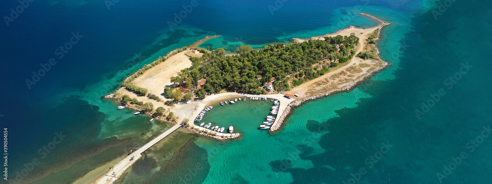 Aerial drone ultra wide photo of famous island of dreams or Pezonisi connecting with small road with seaside fishing village of Eretria, Central Evia island, Greece