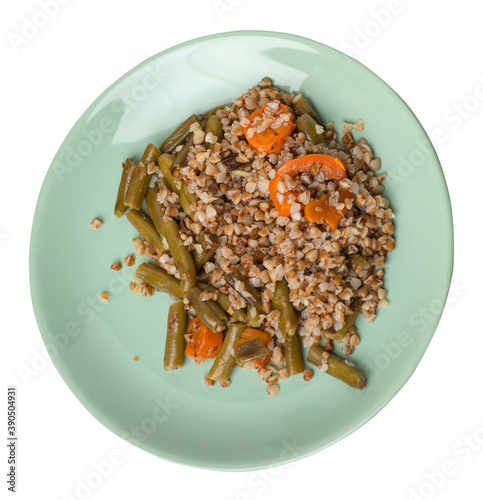 buckwheat with green beans with garlicand carrots isolated on white background. Diet breakfast on a green plate. healthy food vegetarian photo