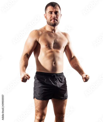 Brutal muscular sportsman standing in black shorts. Over white background.