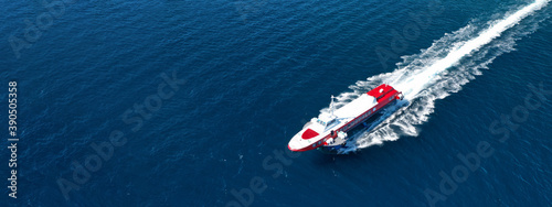 Aerial drone ultra wide photo of Hellenic Seaways high speed passenger ferry or "flying dolphin" cruising in high speed near port of Piraeus, Attica, Greece