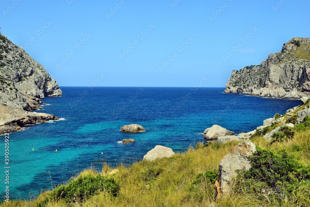 Sea bay with turquoise water, beach and mountains, Cala Figuera on Cap Formentor