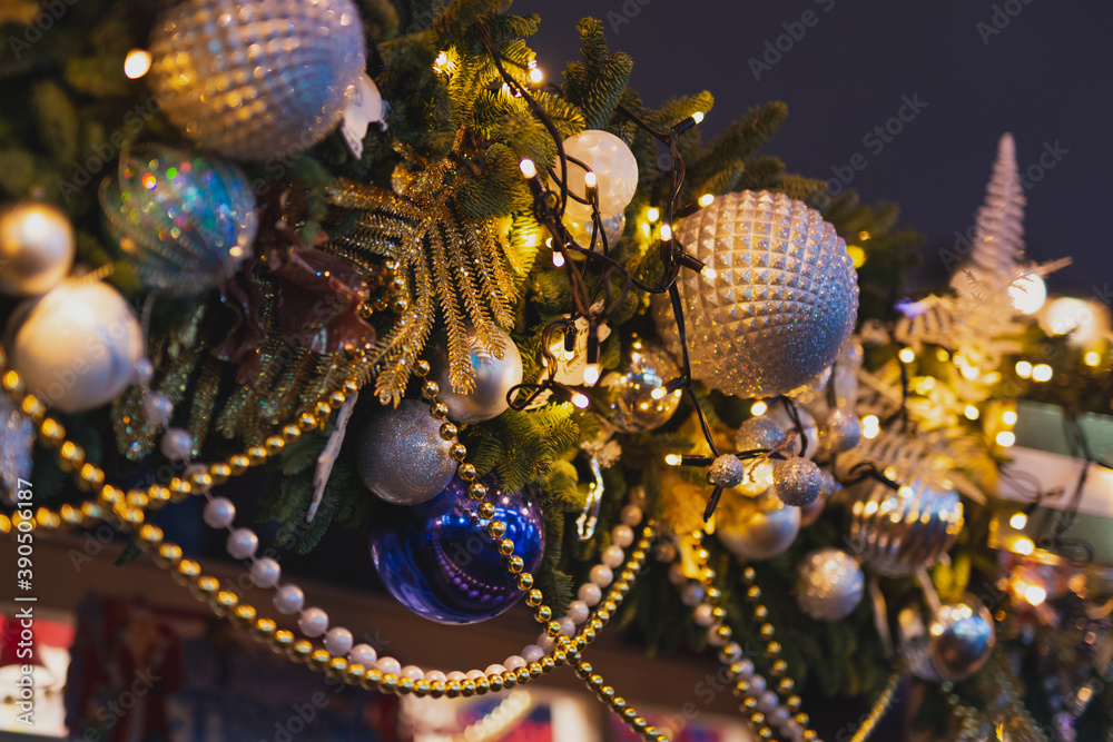 Fototapeta premium New Year decorations. Closeup Christmas lights and balls on the street