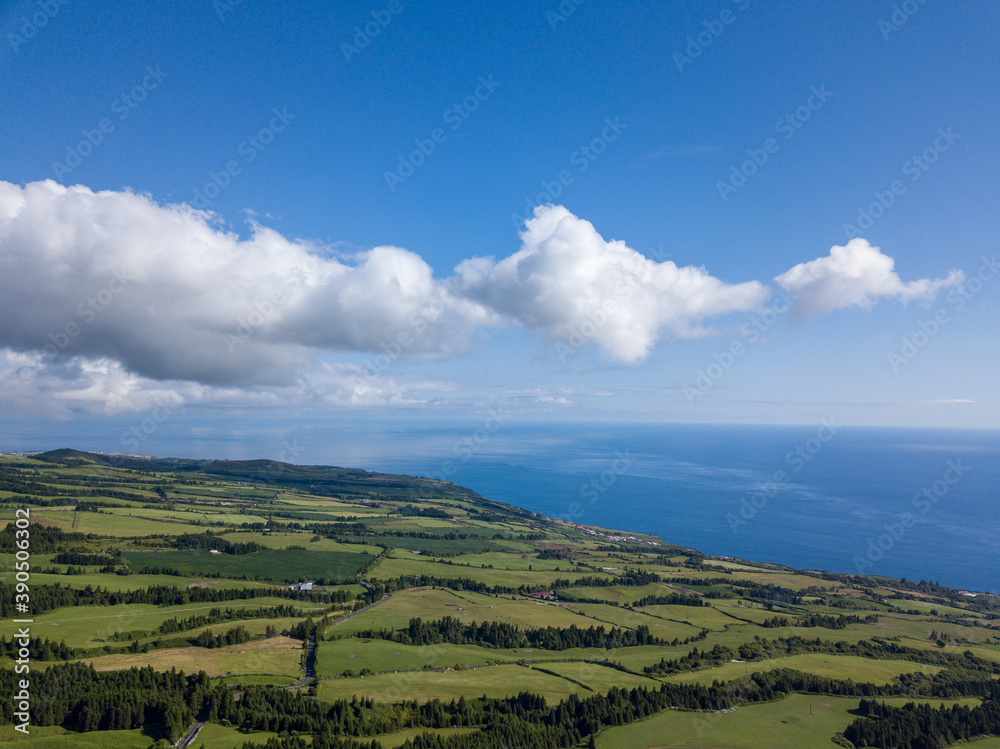 Landscape view over the North Coastline of the Island with blue sky and white clouds and the Atlantic Ocean in the background. São Miguel Island. Azores.