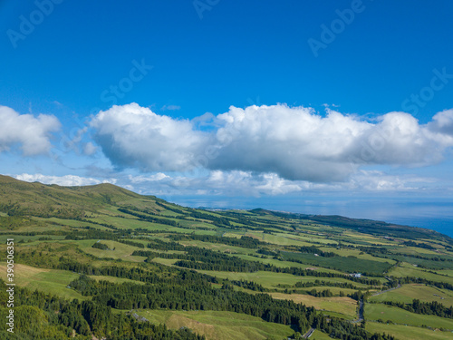 Landscape view over the North Coastline of the Island with blue sky and white clouds over. S  o Miguel Island. Azores.