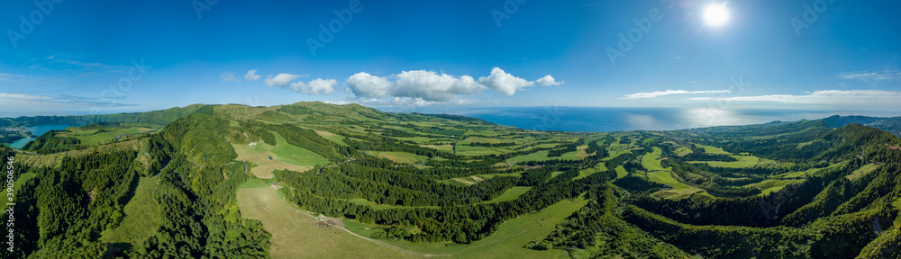 Panoramic view over the luxurious green landscape and the Atlantic ocean, in the zone of Sete Cidades, São Miguel island in the Azores.