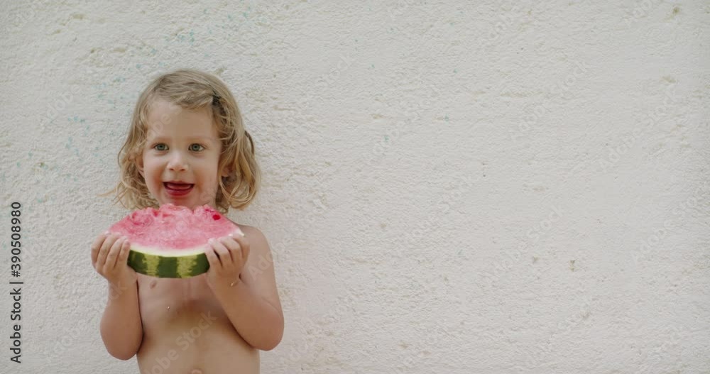 Happy little caucasian baby boy eating a piece of watermelon. Cute joyful kid positively laughing and smiling while eating tasty fruit - happy childhood 4k footage Happy little caucasian baby boy eating a piece of watermelon. Cute joyful kid positively laughing and smiling while eating tasty fruit - happy childhood 4k footage