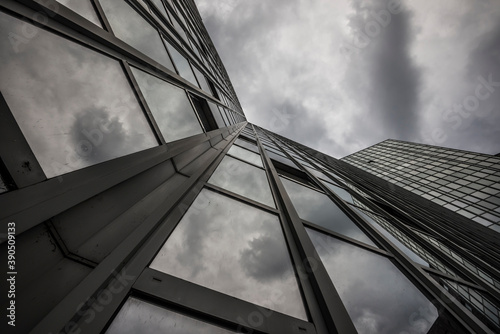 storm clouds in the facade of a modern high rise building photo