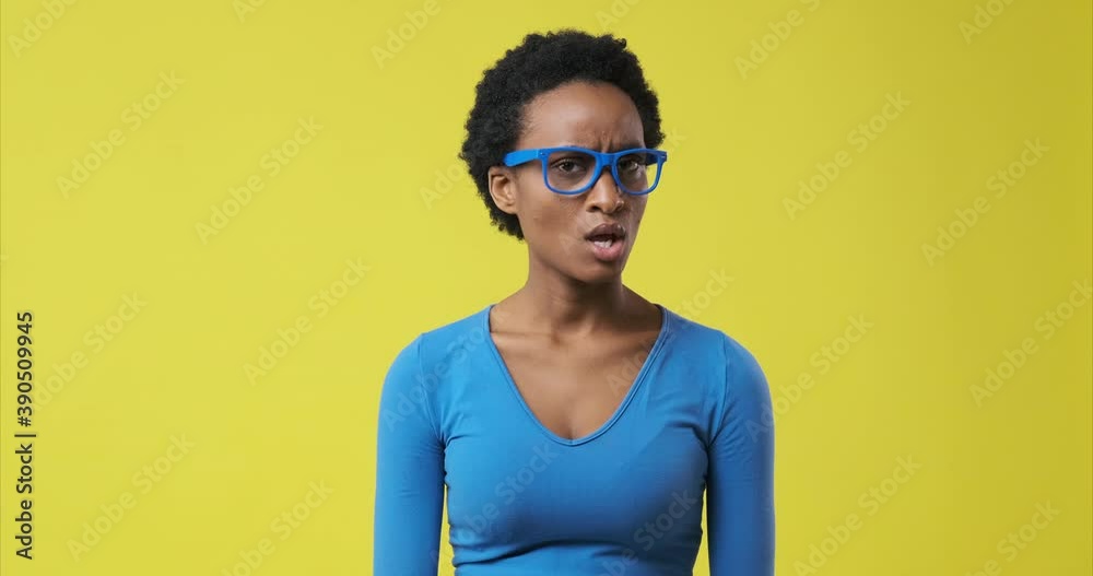 African american woman saying no by waving her finger over yellow background African american woman saying no by waving her finger over yellow background