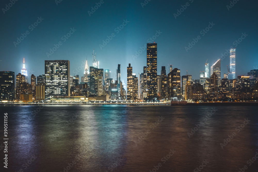 New York City Cityscape during Night Time with busy skyline and dense vibrant skyscrapers filling up the sky and lighting up the city
