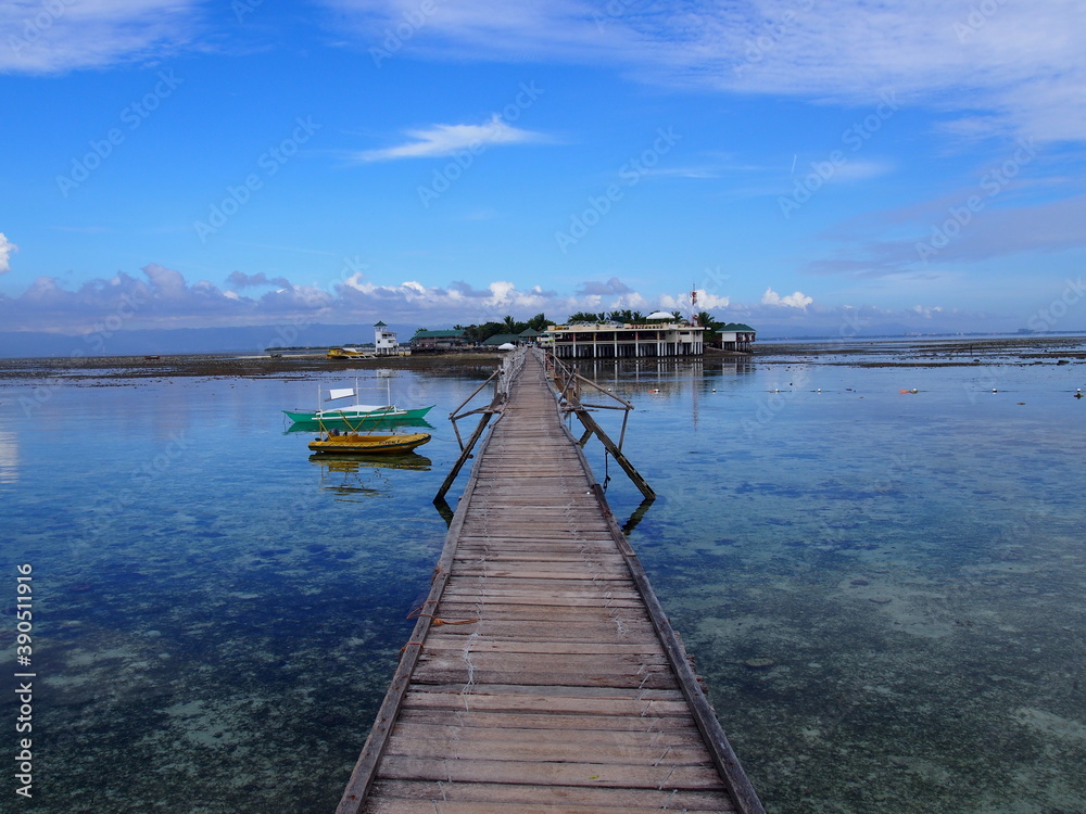 A long wooden bridge leading to the island, Marine Sanctuary, Nalusuan Island, Cebu, Philippines A long wooden bridge leading to the island, Marine Sanctuary, Nalusuan Island, Cebu, Philippines