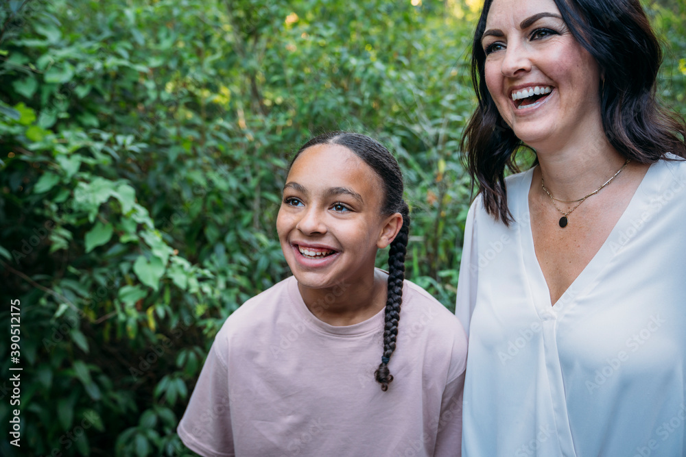 Mother and daughter laughing outside in nature Mother and daughter laughing outside in nature