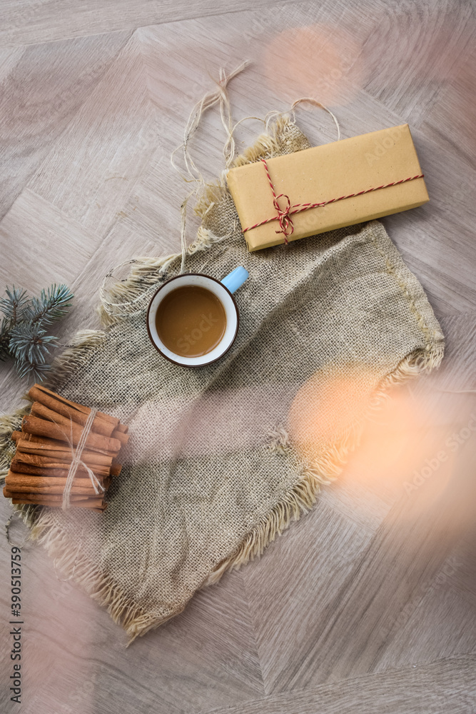 Coffee Cup on Linen Material and Christmas Gift on Beautiful Design Wooden Table Bokeh Defocused Top View Coffee Cup on Linen Material and Christmas Gift on Beautiful Design Wooden Table Bokeh Defocused Top View