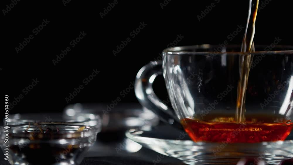 Fresh hot tea is pouring into a cup, refreshing organic beverage, 4k Fresh hot tea is pouring into a cup, refreshing organic beverage, 4k