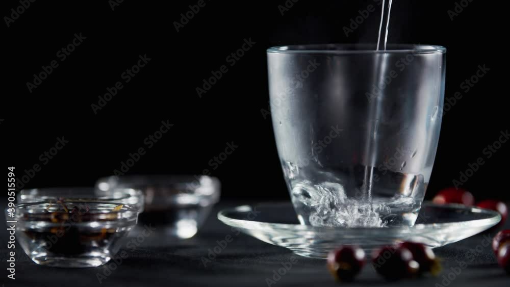 Making tea, pouring hot water into a transparent mug, rosehip and tea, 4k Making tea, pouring hot water into a transparent mug, rosehip and tea, 4k