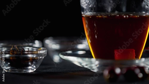 Dropping lump sugar into the hot tea, refreshing beverage, 4k