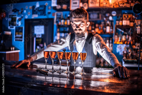 Focused bartender formulates a cocktail in pub
